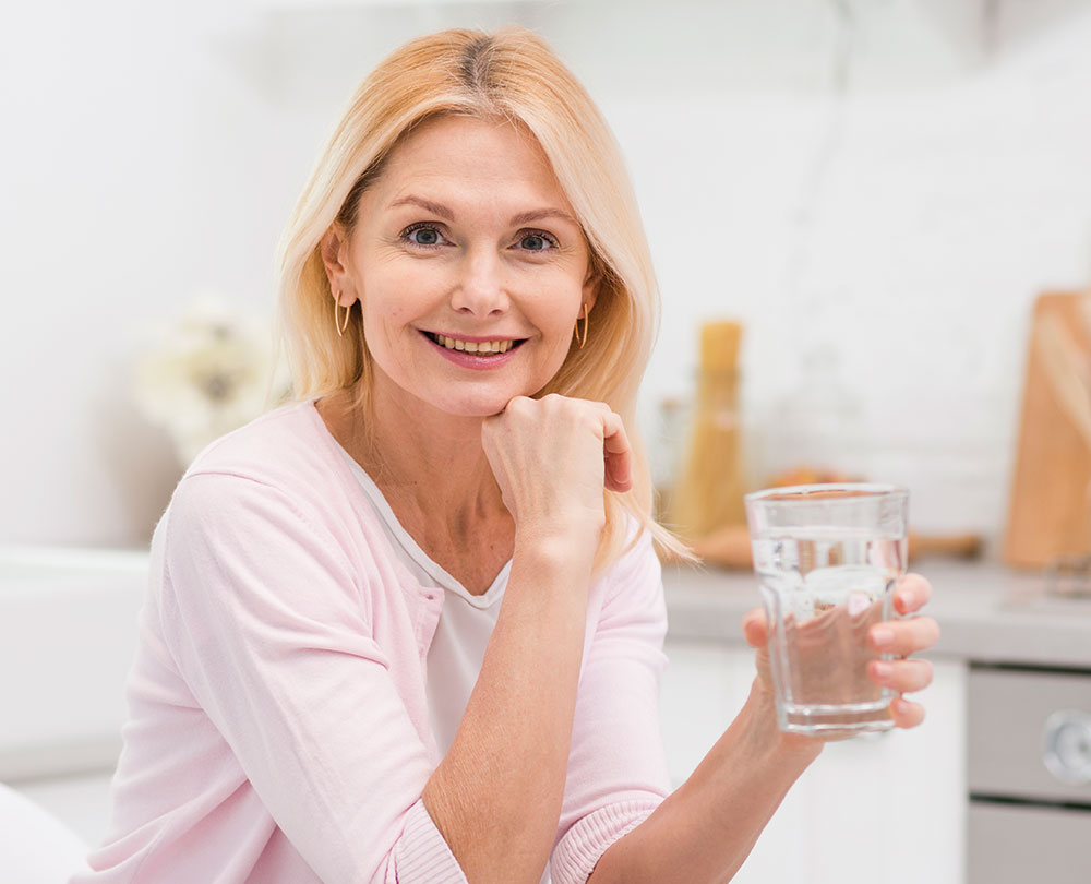 A satisfied customer holding a glass of fresh water